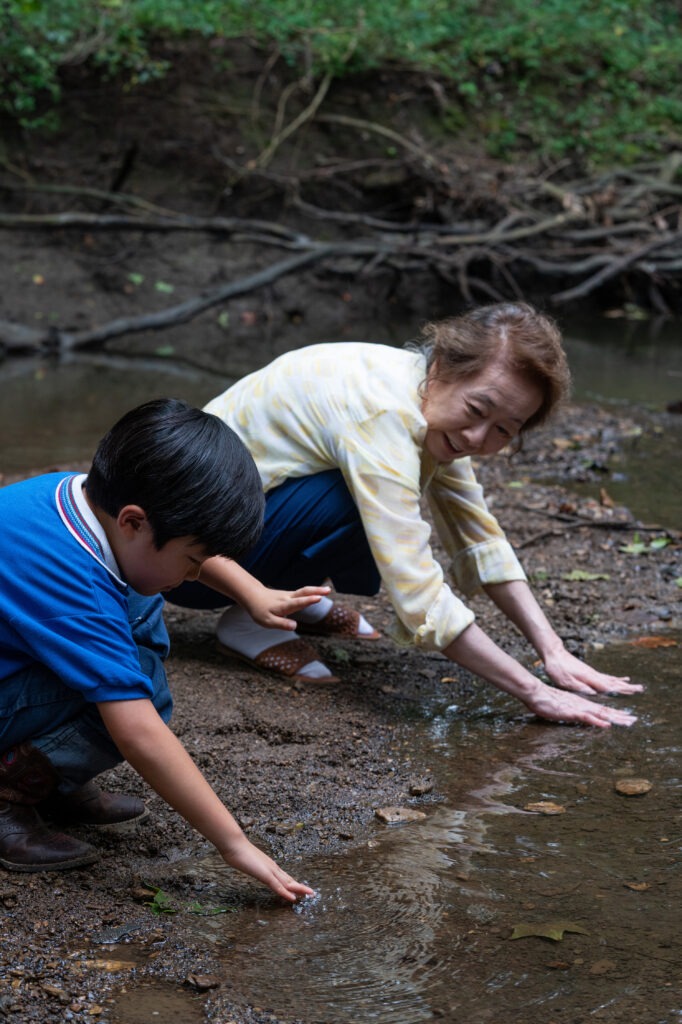 In the film Minari, Soonja develops a special bond with her grandson David, played by Alan Kim. Josh Ethan Johnson/Courtesy of A24