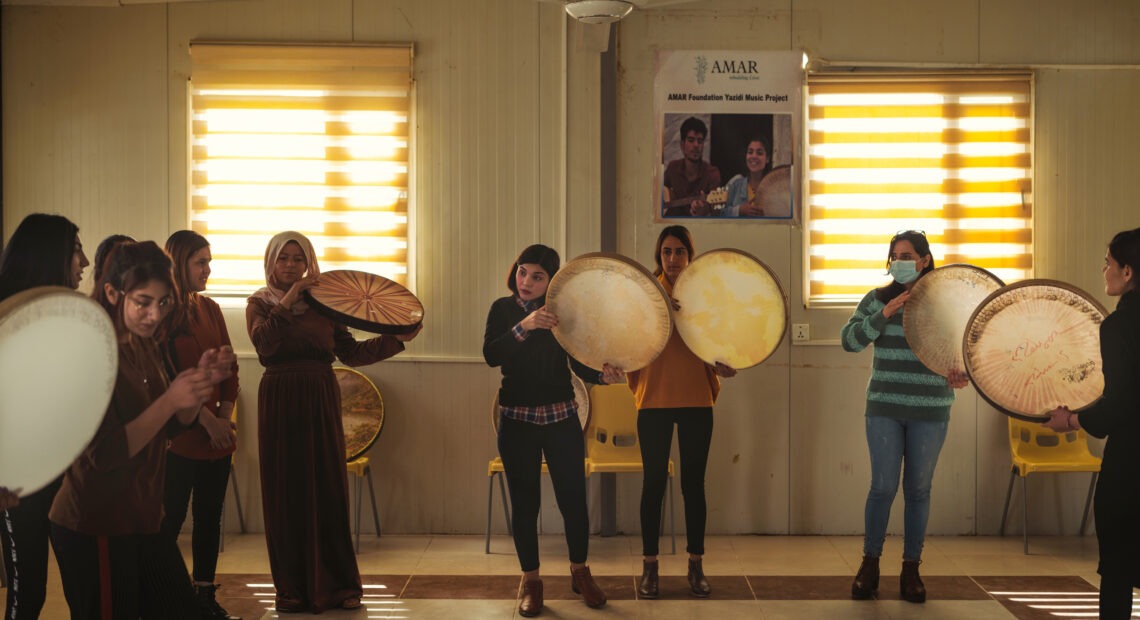 Rana Sulaiman Halo (center), performs with a traditional daf drum with the Ashti (Peace) Choir. Emily Garthwaite/INSTITUTE for NPR