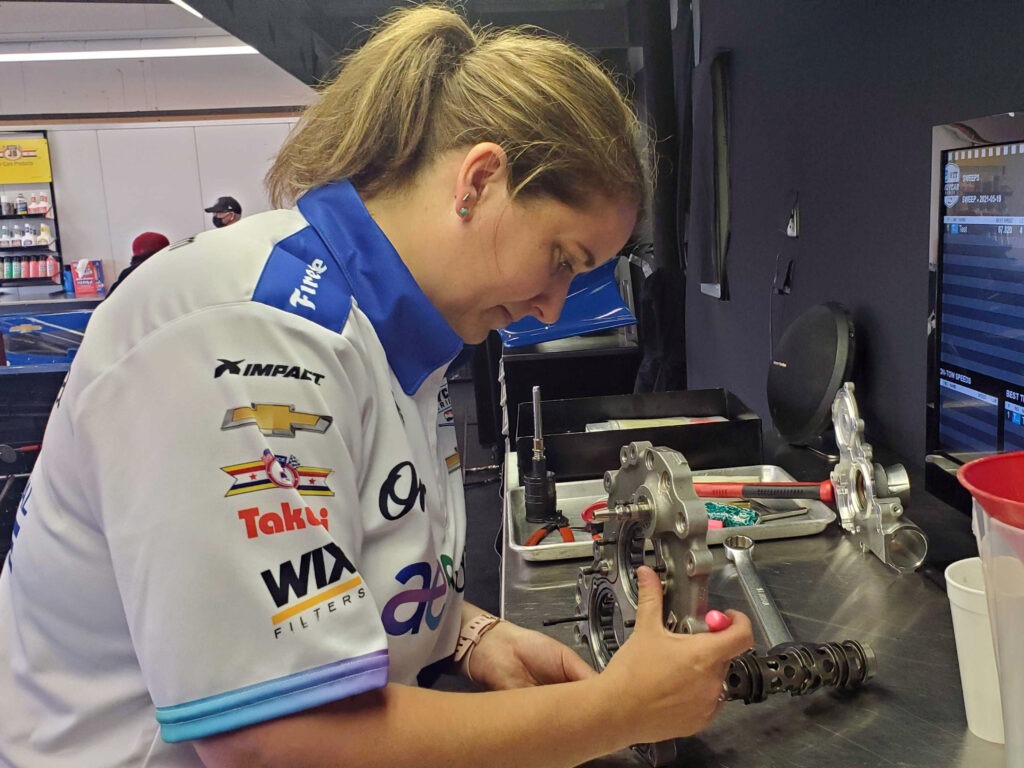 Mechanic Anna Chatten works on a spare gearbox for her team, Dreyer & Reinbold. "If you would have asked me 20 years ago if I thought I would still be a solo wrench turner in the IndyCar paddock, I would have thought you were crazy," she says. CREDIT: Samantha Horton/IPB News