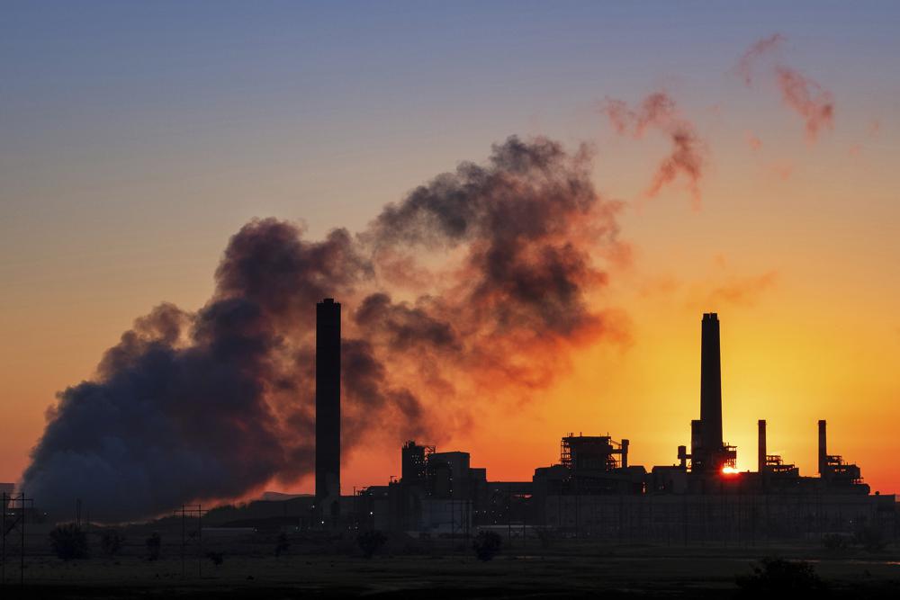 In this July 27, 2018, the Dave Johnson coal-fired power plant is silhouetted against the morning sun in Glenrock, Wyo. A law signed April 6, 2021, by Republican Gov. Mark Gordon creates a $1.2 million fund for an initiative that marks the latest attempt by state leaders to help coal in the state that accounts for the bulk of U.S. coal production, which is down by half since 2008. Wyoming coal production, which accounts for about 40% of the nation's total, has declined as utilities switch to gas, which is cheaper to burn to generate electricity. CREDIT: J. David Ake/AP
