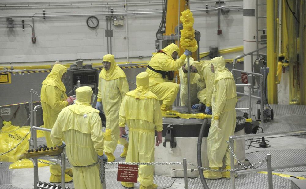 In this May 7, 2013 photo released by Idaho National Laboratory, nuclear operations professional personnel work above the Advanced Test Reactor at Idaho National Laboratory's desert site about 50 miles west of Idaho Falls, Idaho. The small cylindrical section in the center of the platform has access ports that allow access to the reactor core for refueling and experiment loading and unloading during routine outages. The platform, a layer of shield blocks totalling more than 150,000 lbs, and then the 62,000-lb reactor vessel top head are temporarily removed in order to complete the ATR core overhaul. CREDIT: Idaho National Laboratory via AP