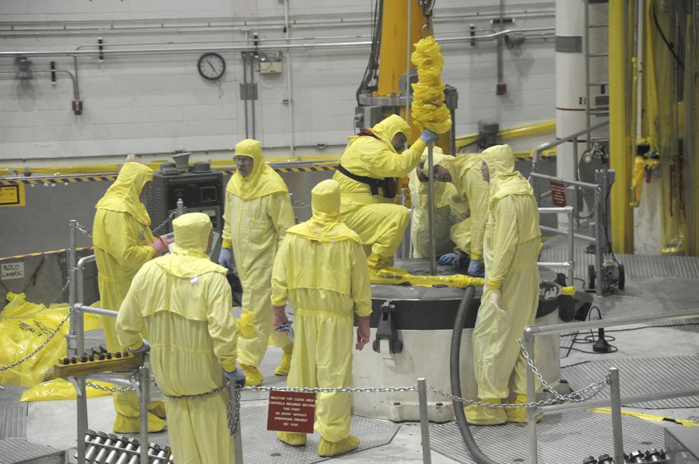 In this May 7, 2013 photo released by Idaho National Laboratory, nuclear operations professional personnel work above the Advanced Test Reactor at Idaho National Laboratory's desert site about 50 miles west of Idaho Falls, Idaho. The small cylindrical section in the center of the platform has access ports that allow access to the reactor core for refueling and experiment loading and unloading during routine outages. The platform, a layer of shield blocks totalling more than 150,000 lbs, and then the 62,000-lb reactor vessel top head are temporarily removed in order to complete the ATR core overhaul. CREDIT: Idaho National Laboratory via AP