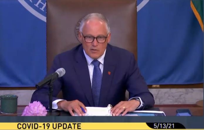Washington Gov. Jay Inslee, not wearing a face mask following new guidance from the federal CDC, said on Thursday, May 13, that the state is on track for a fully reopening by June 30. CREDIT: TVW/screenshot