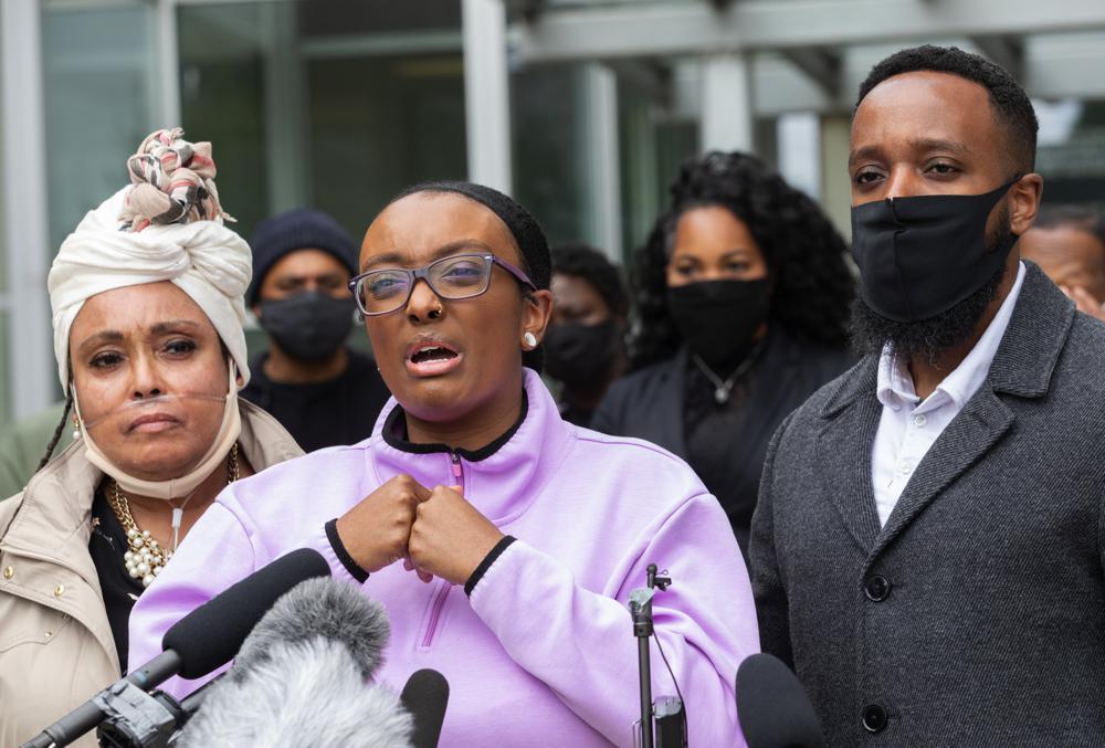 Monet Carter-Mixon, center, the sister of Manuel Ellis, speaks at a press conference in this June 4, 2020 photo, as Ellis' mother, Marcia Carter-Patterson, left, and brother, Matthew Ellis, right, look on. On Thursday, May 27, 2021, the Washington state attorney general filed criminal charges against three police officers in the death of Ellis, a Black man who died after telling the Tacoma officers who were restraining him he couldn't breathe. CREDIT: Ellen M. Banner/The Seattle Times via AP