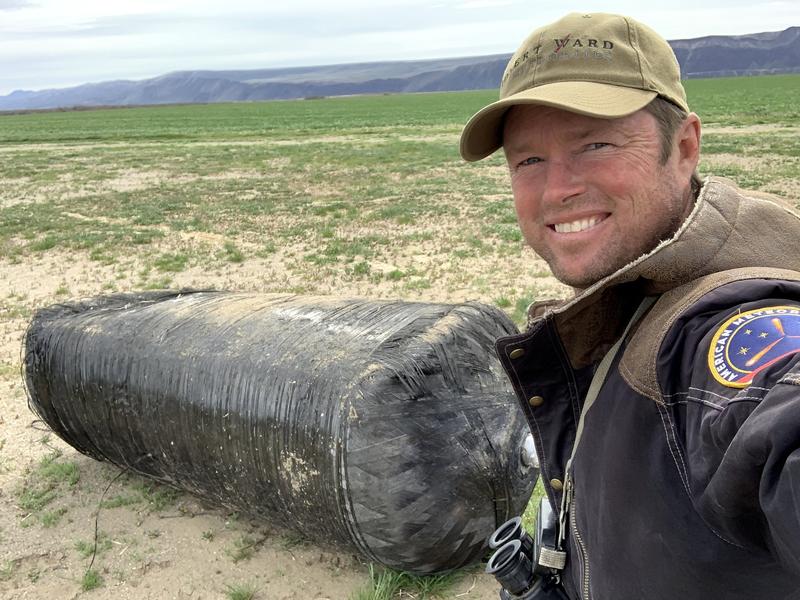 Meteorite hunter Robert Ward with a SpaceX rocket tank that survived fiery reentry. He found it at the edge of a farm field near Beverly in central Washington. Courtesy of Robert Ward
