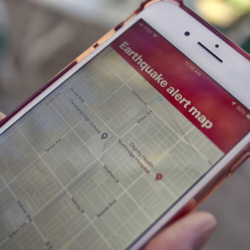 A mobile phone customer in Los Angeles looks at an earthquake warning application on an iPhone. An earthquake early warning system operated by the U.S. Geological Survey has been activated in Oregon, California and now Washington. Richard Vogel/AP