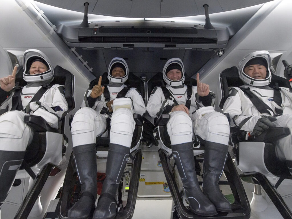 NASA astronauts Shannon Walker (left), Victor Glover, and Mike Hopkins, along with Japan Aerospace Exploration Agency astronaut Soichi Noguchi, are seen inside the SpaceX Crew Dragon Resilience spacecraft onboard the SpaceX GO Navigator recovery ship shortly after landing in the Gulf of Mexico off the coast of Panama City, Fla., on Sunday. CREDIT: Bill Ingalls/AP