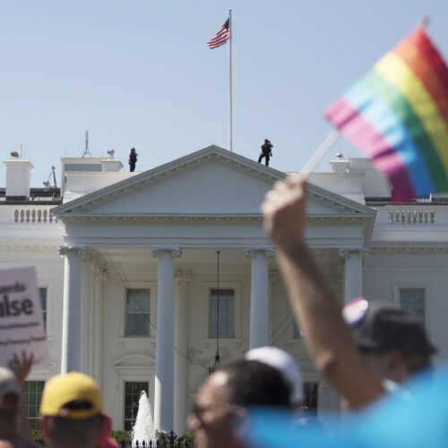 In this June 11, 2017 file photo, Equality March for Unity and Pride participants march past the White House in Washington. The Biden administration says the government will protect gay and transgender people against sex discrimination in health care. That reverses a Trump-era policy that sought to narrow the scope of legal rights in sensitive situations involving medical care. Health and Human Services Secretary Xavier Becerra said Monday that LGBTQ people should have the same access to health care as everyone else. T(AP Photo/Carolyn Kaster)