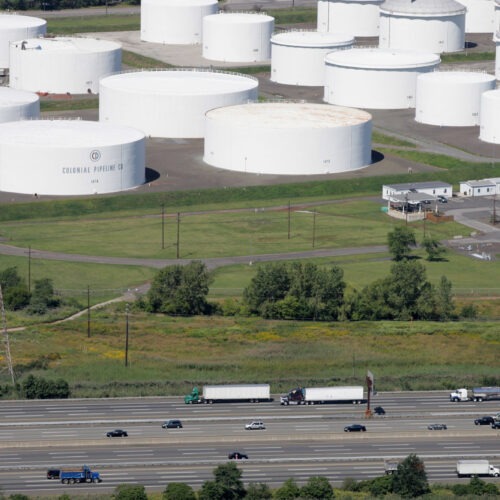 Traffic on I-95 passes oil storage tanks owned by the Colonial Pipeline Co. in Linden, N.J. An cybersecurity attack has shut down Colonial Pipeline, a major transporter of gasoline along the East Coast. CREDIT: Mark Lennihan/AP