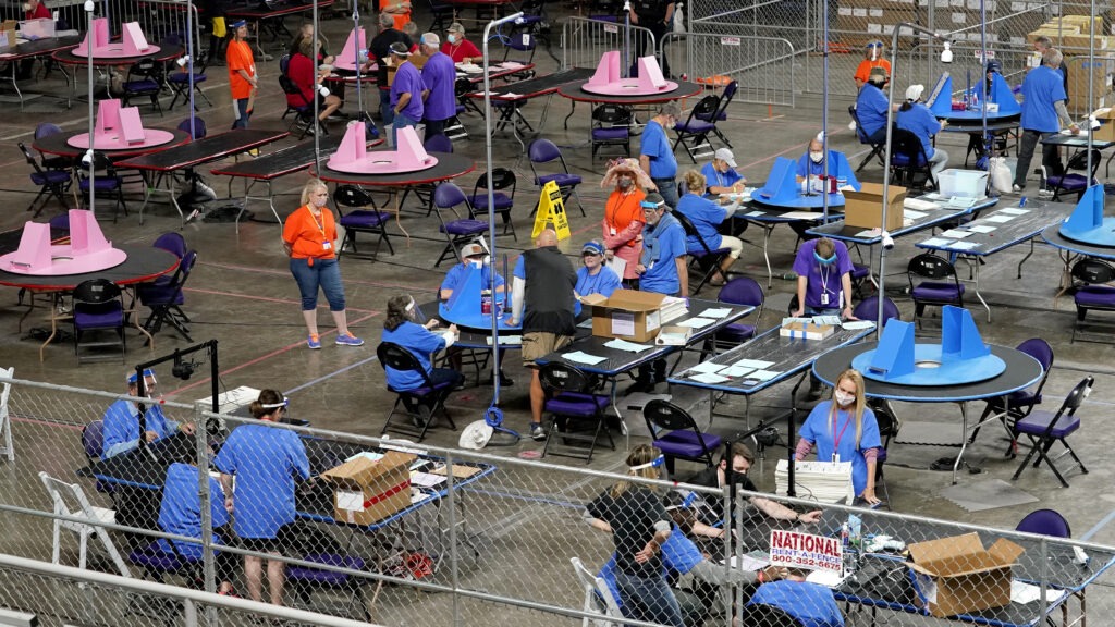 Maricopa County ballots cast in the 2020 general election are examined and recounted Thursday by contractors hired by the Republican-led Arizona Senate. CREDIT: Matt York/AP