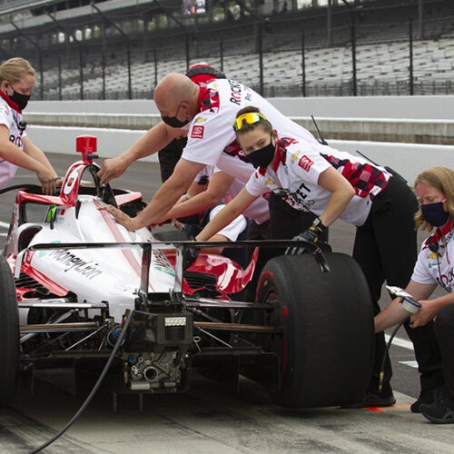 Paretta Autosport crew members work on their car in pit lane at the Indianapolis Motor Speedway during a practice session earlier this week. It could become the first majority-women team to qualify for the Indy 500. CREDIT: Doug Jaggers/WFYI