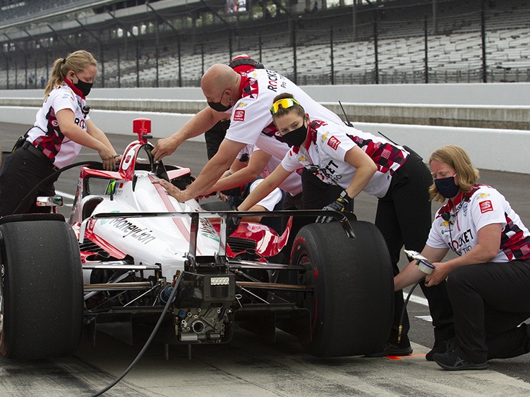 Paretta Autosport crew members work on their car in pit lane at the Indianapolis Motor Speedway during a practice session earlier this week. It could become the first majority-women team to qualify for the Indy 500. CREDIT: Doug Jaggers/WFYI