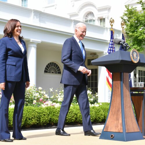 President Biden arrives with Vice President Harris to discuss the CDC's new mask guidance in the Rose Garden of the White House on Thursday. CREDIT: Nicholas Kamm/AFP via Getty Images