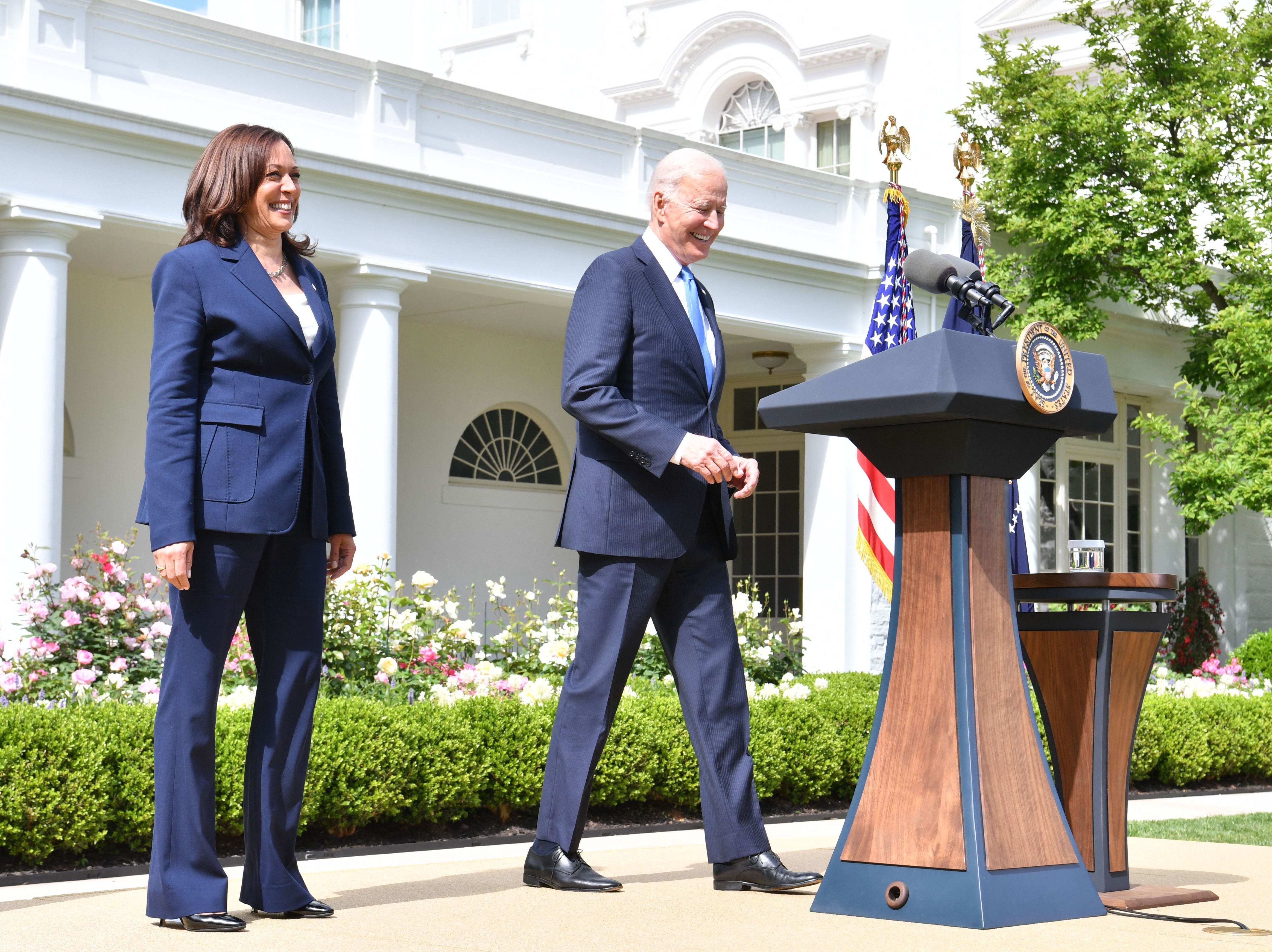 President Biden arrives with Vice President Harris to discuss the CDC's new mask guidance in the Rose Garden of the White House on Thursday. CREDIT: Nicholas Kamm/AFP via Getty Images