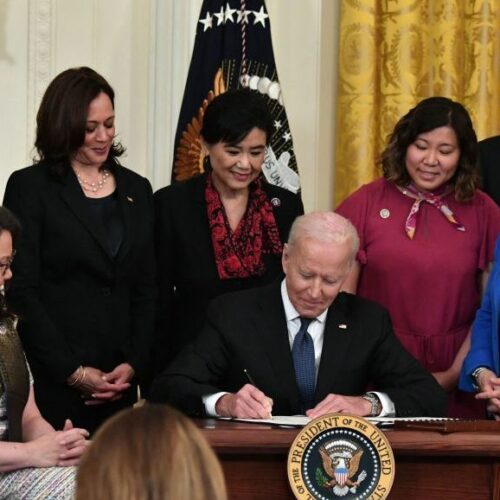 President Biden signs into law the COVID-19 Hate Crimes Act on Thursday in the East Room of the White House. CREDIT: Nicholas Kamm/AFP via Getty Images
