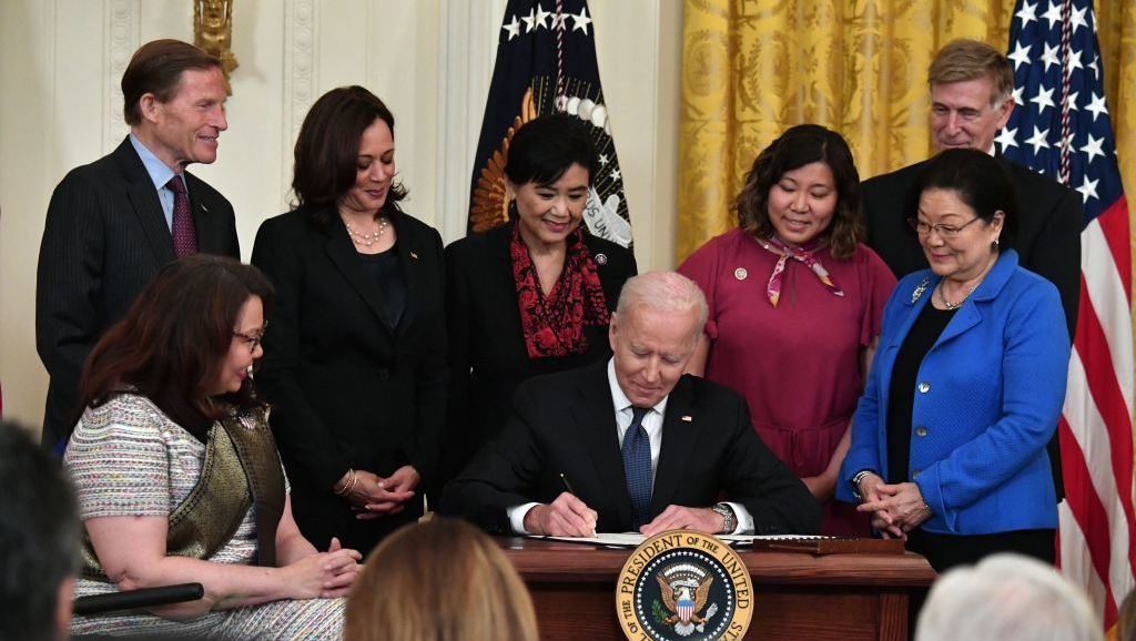 President Biden signs into law the COVID-19 Hate Crimes Act on Thursday in the East Room of the White House. CREDIT: Nicholas Kamm/AFP via Getty Images