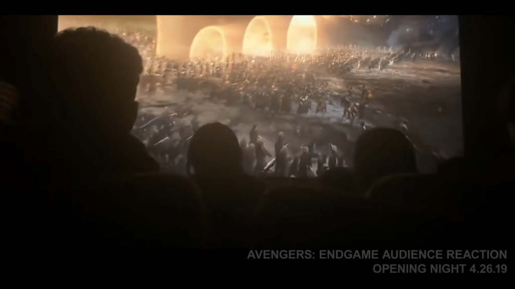 Theater patrons cheering at the climax of an Avengers Endgame screening — a moment of shared excitement experienced by many millions of movie patrons worldwide — is part of the sell Marvel is offering as it welcomes audiences back to cinemas, as seen in this screenshot. YouTube