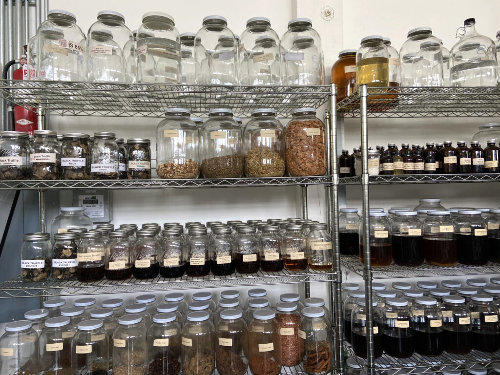 Jamie Hunt and Holly Robinson use all sorts of local ingredients and herbs in their amaro liqueurs. In the back of the distillery, tinctures and botanicals line the walls. A dehydrator dries out truffles for future batches while another jar of the black bulbs sits nearby. CREDIT: Courtney Flatt/NWPB