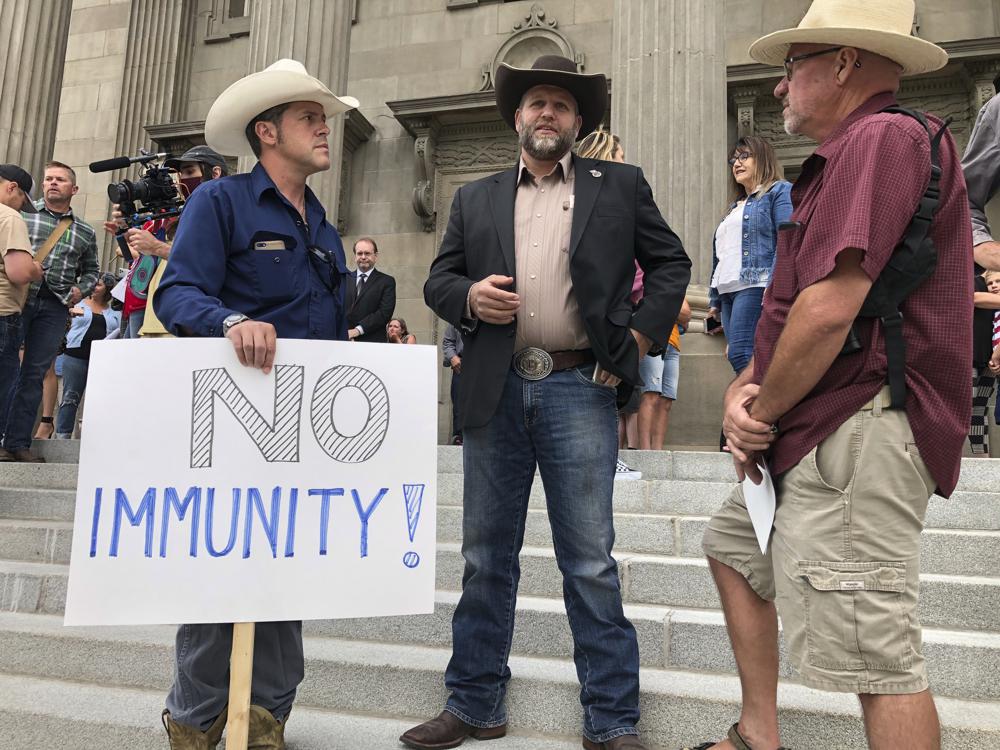 Ammon Bundy, center, who led the Malheur National Wildlife Refuge occupation, stands on the Idaho Statehouse steps in Boise. Mainstream and far-right Republicans are battling for control of the party and the state in deeply conservative Idaho. CREDIT: Keith Ridler/AP