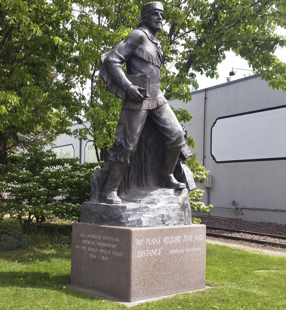 File photo, 2015. A statue of Marcus Whitman stands on city property just outside the Whitman College campus in Walla Walla, Wash. For generations, Whitman has been viewed as an iconic figure from early Pacific Northwest history, a venerated Protestant missionary who was among 13 people killed by the Cayuse tribe near modern-day Walla Walla, Washington, in 1847. But this past year has seen the continued reappraisal of Whitman, whose actions are now viewed by many as imperialistic and destructive, and the Washington Legislature voted to remove a similar statue of Whitman from Statuary Hall in Washington, D.C. CREDIT: Tom Skeen/Walla Walla Union-Bulletin via AP