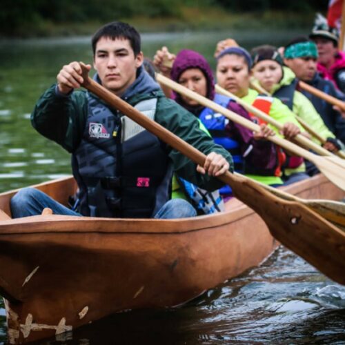 Nez Perce tribal members paddle on the Snake River in a canoe they carved as part of a culture and environmental learning project supported by the Potlatch Fund.