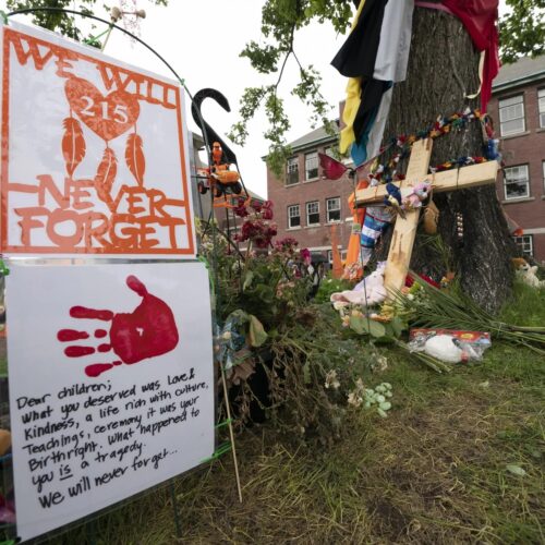 A memorial stands outside the Residential School in Kamloops, British Columbia. The remains of 215 children were discovered buried near the former Kamloops Indian Residential School earlier this month. Jonathan Hayward/The Canadian Press via AP