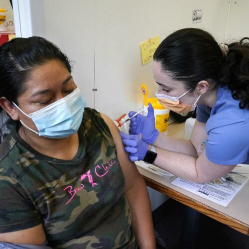 Medical assistant Andreea Marian, right, gives a COVID-19 vaccine to Gabina Morales at a clinic at PeaceHealth St. Joseph Medical Center Thursday, June 3, 2021, in Bellingham, Wash. Washington is the latest state to offer prizes to encourage people to get vaccinated against COVID-19, with Gov. Jay Inslee announcing a series of giveaways during the month of June that includes lottery drawings totaling $2 million, college tuition assistance, airline tickets and game systems. CREDIT: Elaine Thompson/AP