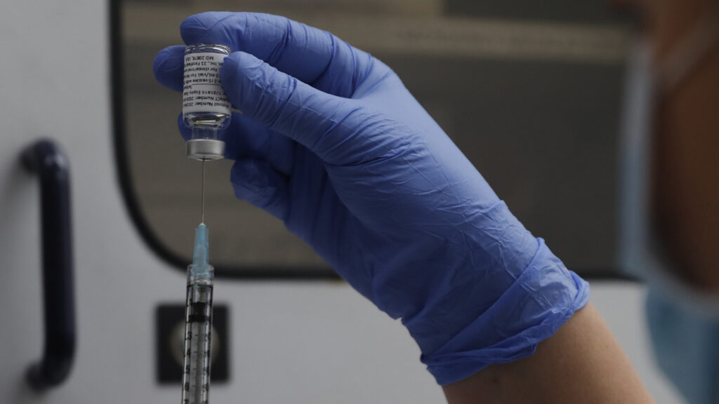 A vial of the Phase 3 Novavax coronavirus vaccine is seen ready for use in the trial at St. George's University hospital in London Wednesday, Oct. 7, 2020. Novavax Inc. said Thursday Jan. 28, 2021 that its COVID-19 vaccine appears 89% effective based on early findings from a British study and that it also seems to work — though not as well — against new mutated strains of the virus circulating in that country and South Africa. (AP Photo/Alastair Grant)