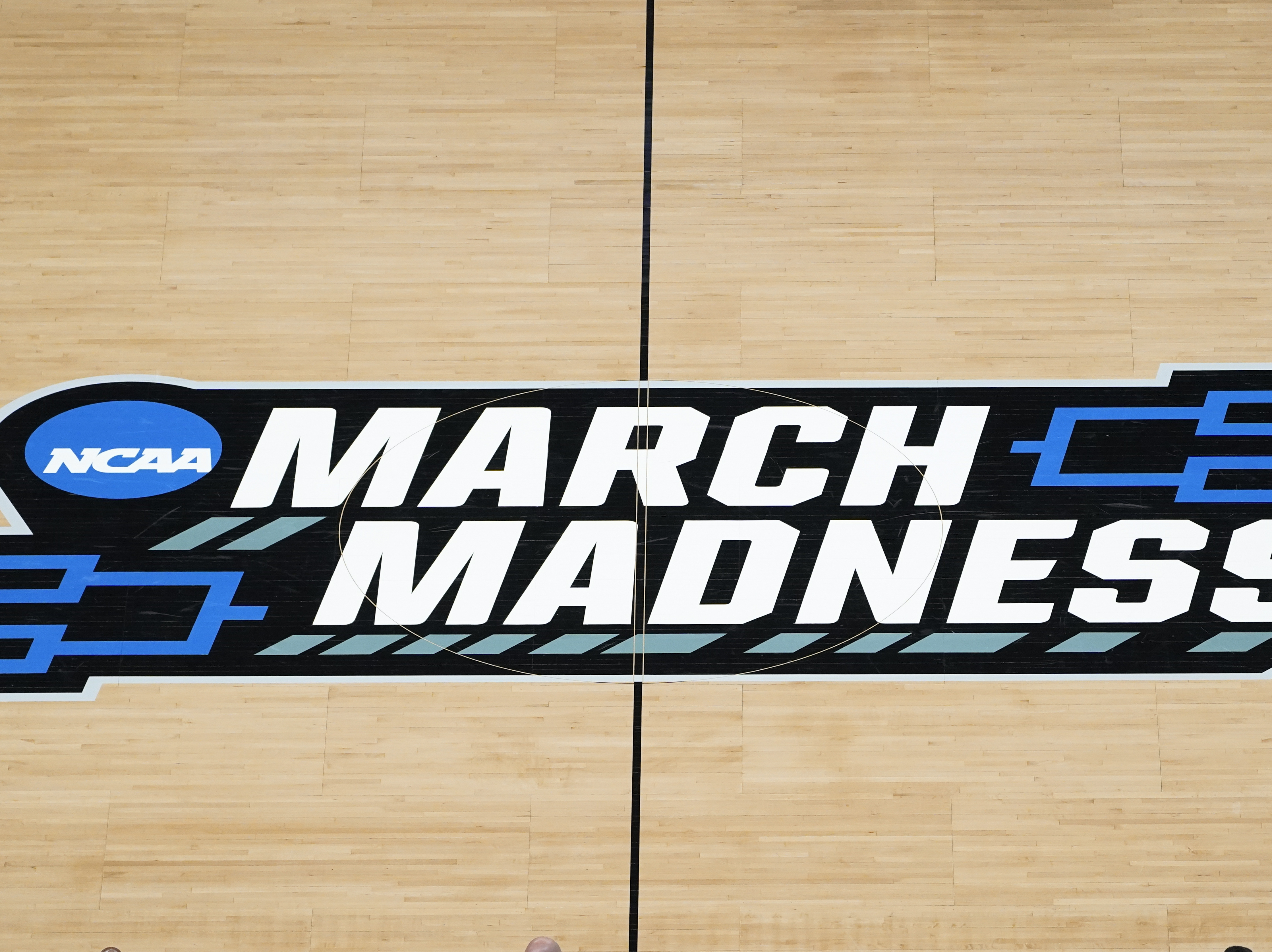 The March Madness logo on the court during a men's college basketball game during the NCAA tournament in Indianapolis. The Supreme Court has eroded the difference between elite college athletes and professional sports stars.