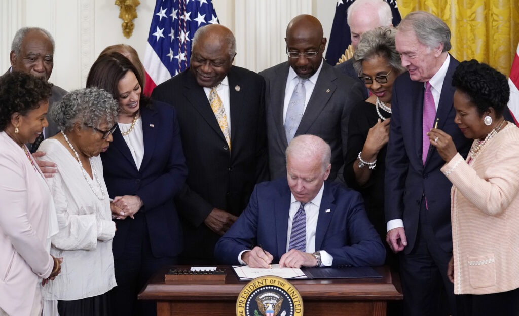 President Joe Biden signs the Juneteenth National Independence Day Act in the East Room of the White House on Thursday. CREDIT: Evan Vucci/AP