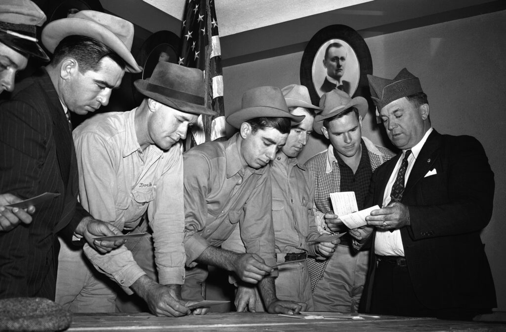 A group registers for military selective service at the state fair grounds in Dallas in 1940. The Supreme Court said Monday it would not hear a case challenging the rule that only men need to register for the draft. AP