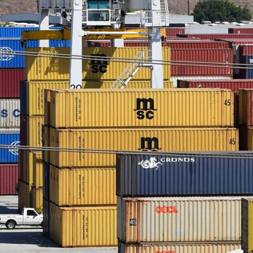 Shipping containers are stacked high at the Port of Los Angeles in April. Supply chain disruptions are hitting small-business owners across the United States. CREDIT: Frederic J. Brown/AFP via Getty Images
