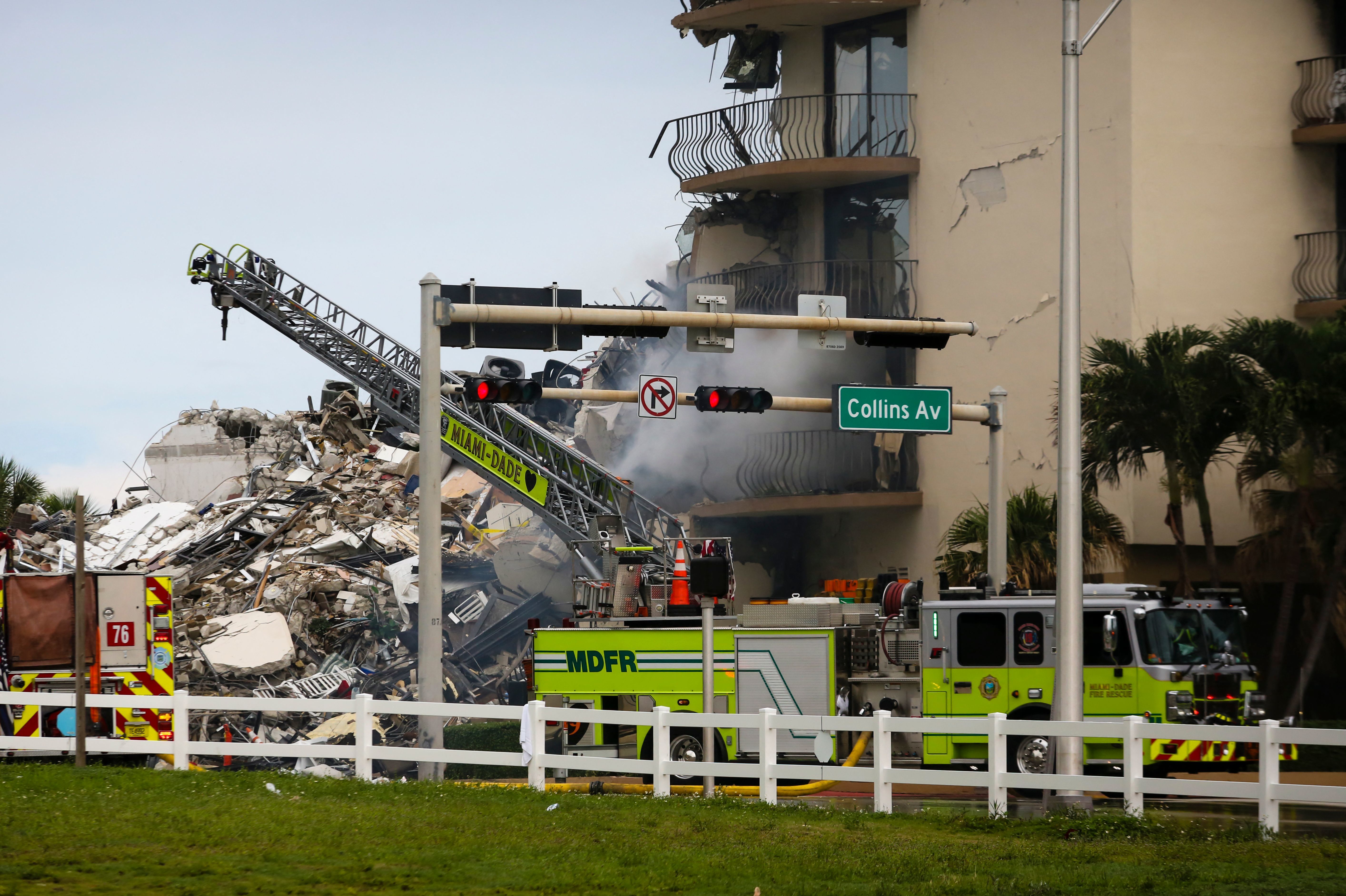 A Miami-Dade Fire Rescue truck is seen Thursday in front of debris from the partially collapsed Champlain Towers South complex in Surfside, Fla., north of Miami Beach. CREDIT: Eva Marie Uzcategui/AFP via Getty Images