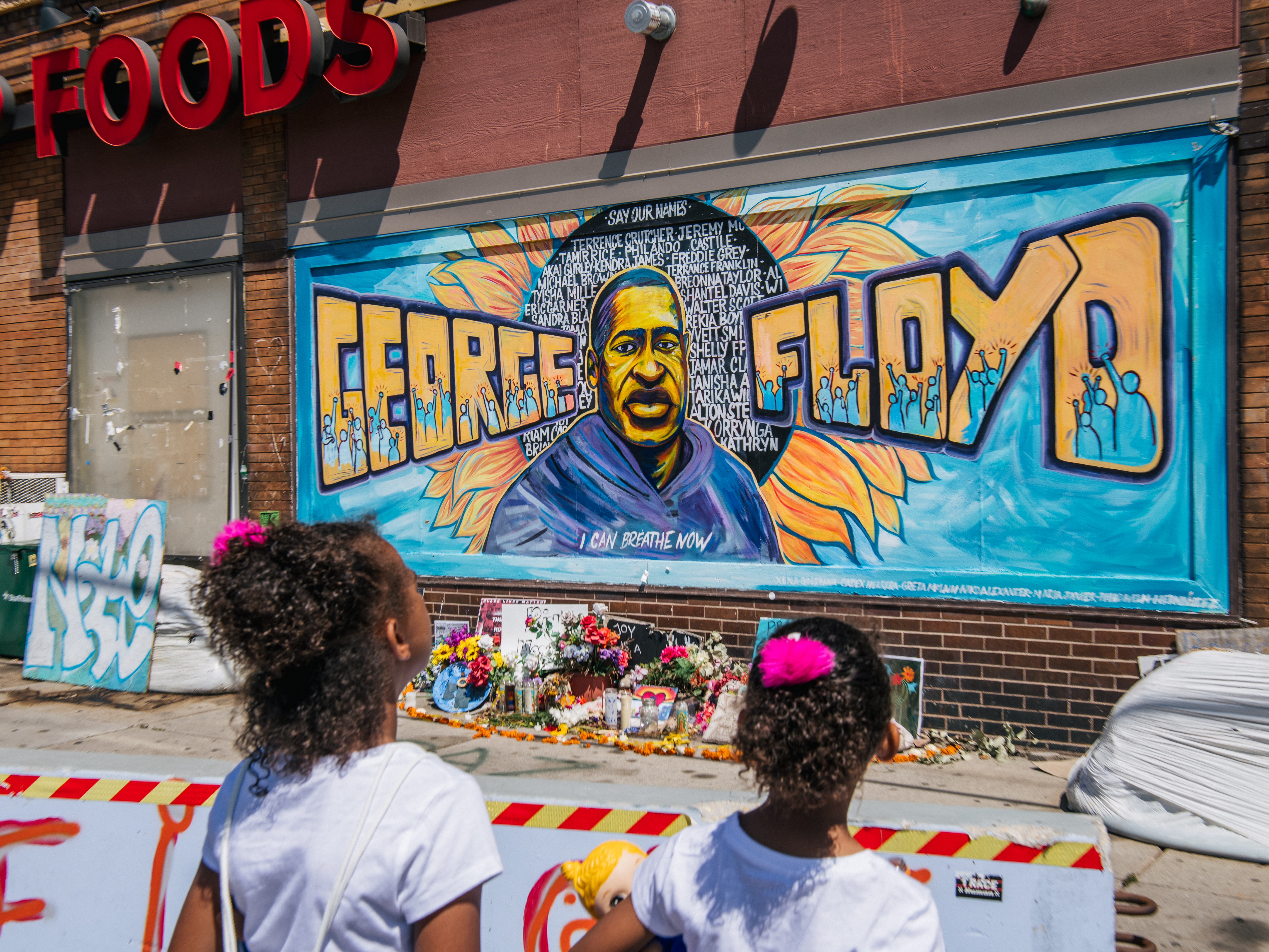 Jordan and Royal Pacheco view a mural of Floyd on Friday in Minneapolis ahead of Chauvin's sentencing. Brandon Bell/Getty Images
