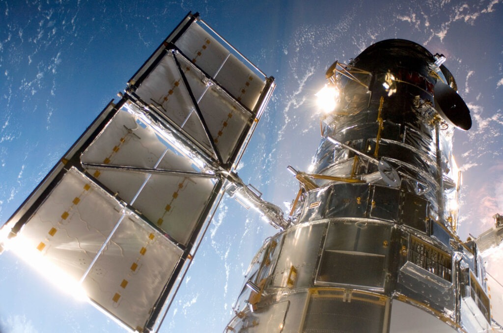 In this handout from NASA, the Hubble Space Telescope is grappled to Space Shuttle Atlantis STS-125 by the shuttle's Canadian-built remote manipulator system May 13, 2009 in Space. CREDIT: NASA/Getty Images