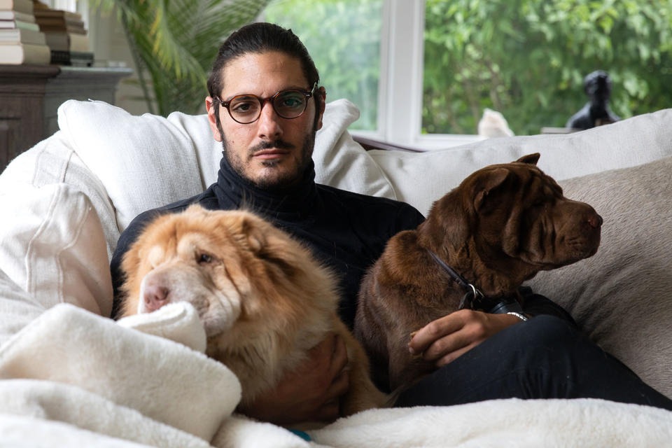 Abraham Dairi spends time with his dogs Ziggy, 3, and Bowie, 4, at his home in Seattle's Montlake neighborhood on July 1, 2021. CREDIT: Matt M. McKnight/Crosscut