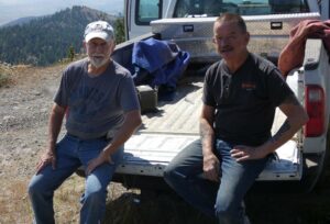 two men on tailgate of truck