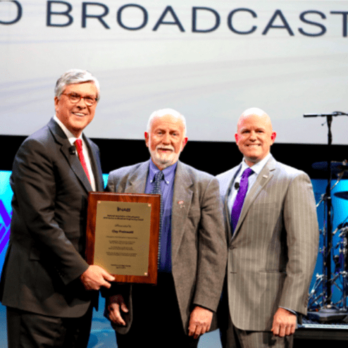 image shows Clay Freinwald on stage receiving award.