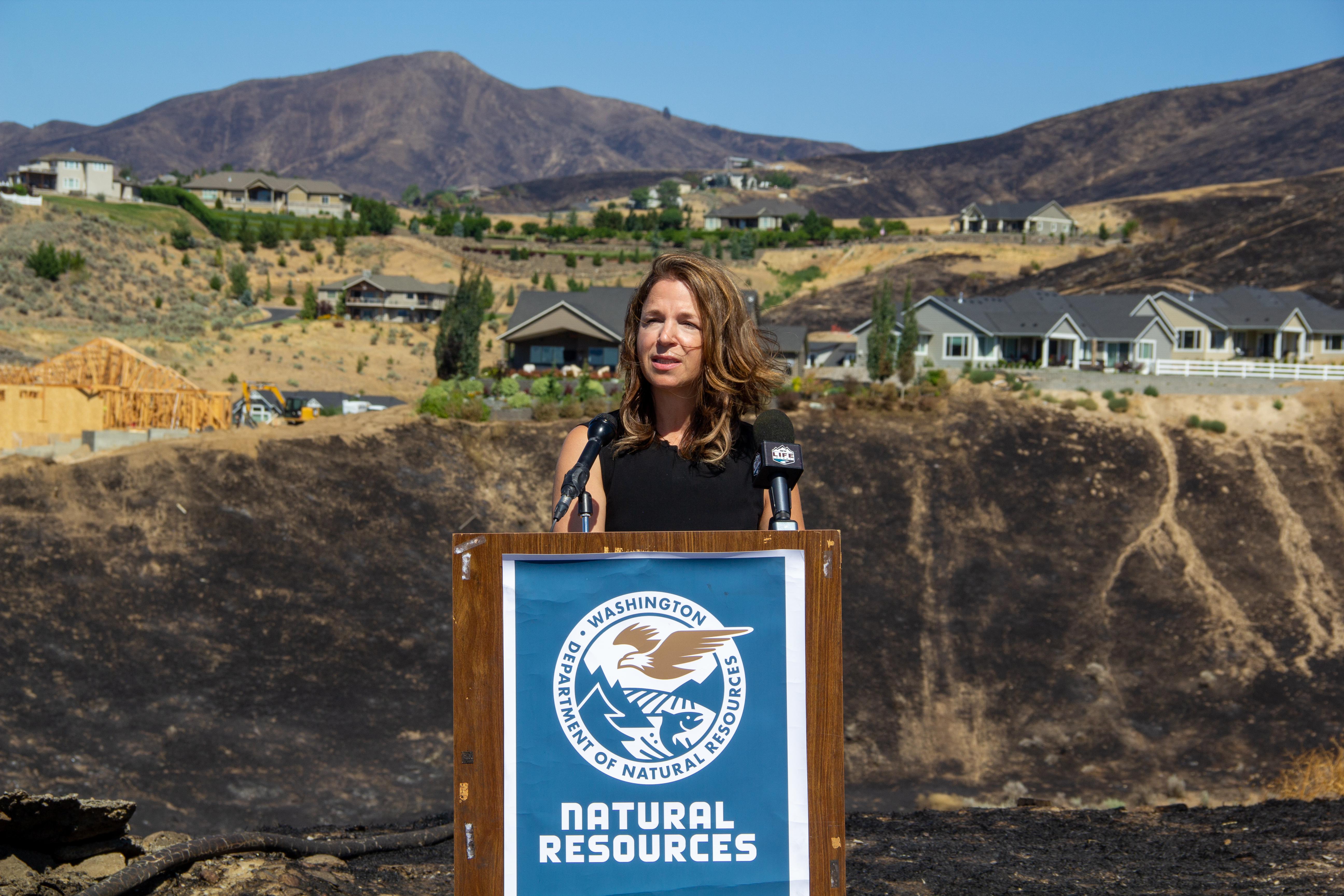 Public Lands Commissioner Hilary Franz speaking at a podium.