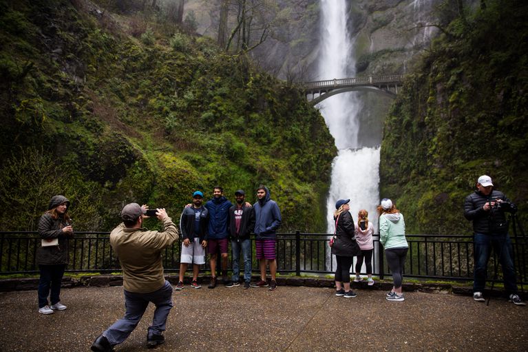 Tourists take pictures next to Multnomah Falls, April 13, 2018. CREDIT: Bradley W. Parks / OPB
