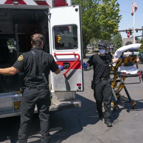 Salem Fire Department paramedics and employees of Falck Northwest ambulances respond to a heat exposure call during a heat wave, June 26, 2021, in Salem, Ore. CREDIT: Nathan Howard/AP