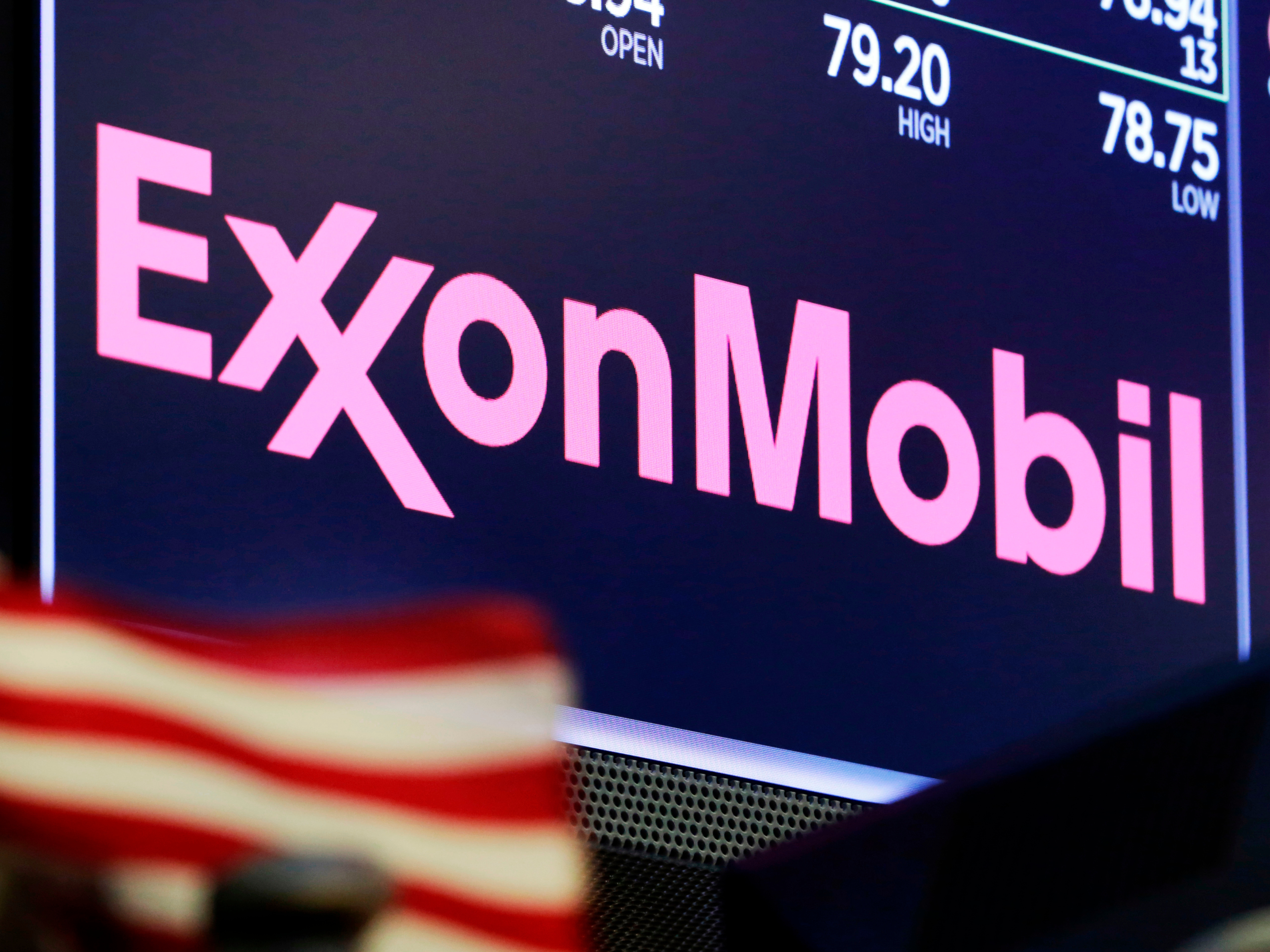 The logo for ExxonMobil above a trading post on the floor of the New York Stock Exchange. The company has apologized after one of its lobbyists talked about undermining climate action in an undercover video. CREDIT: Richard Drew/AP