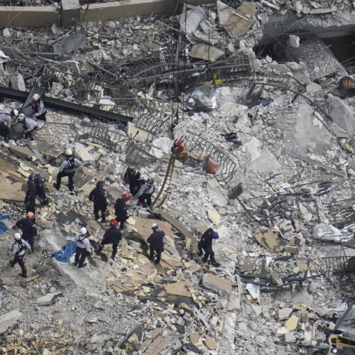 Rescue workers search in the rubble at the Champlain Towers South condo in Surfside, Fla., on June 26. CREDIT: Gerald Herbert/AP