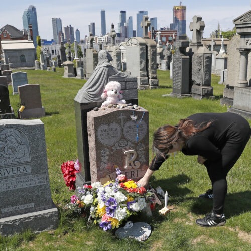 Sharon Rivera adjusts flowers at daughter Victoria's grave at Calvary Cemetery in New York City in 2020. Her daughter, 21, died of a drug overdose in 2019. According to new CDC data, drug overdose deaths soared to more than 93,000 last year. Kathy Willens/AP