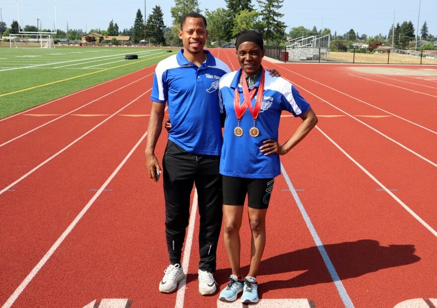 Chambers and Hanna stand on the running field together.