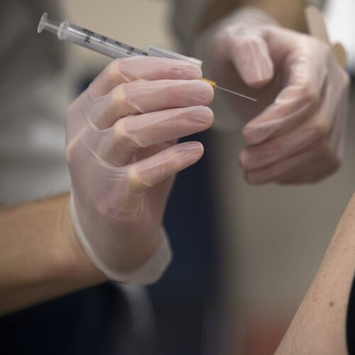 Pharmacist Rui Wen prepares to administer a Johnson & Johnson Covid-19 vaccine for an employee of the Safeway Distribution Center on Monday, March 22, 2021, in Auburn.