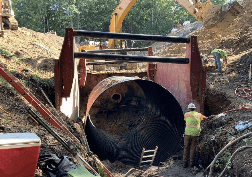 Crews in Bellingham replace an old culvert (center) with a new 12-foot diameter pipe. The old culvert was too smalland sat too high for juvenile fish to navigate during their migration to their spawning grounds.