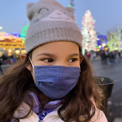 In this file photo from December 2020, a child wears a mask to protect from COVID-19 while attending a Christmas celebration in Leavenworth. Gov. Jay Inslee on Thursday announced he's expanding his statewide mask mandate to include large, outdoor events.