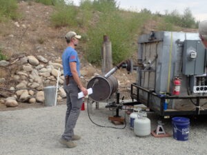 Board member Bret Richmond monitoring the thermal oxidizer as it combusts vapors generated by the pyrolysis process.