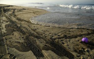 Oil is seen on the beach in Huntington Beach, California on October 3, 2021, after a pipeline breach connected to an oil rig off shore started leaking oil, according to an Orange County Supervisor.